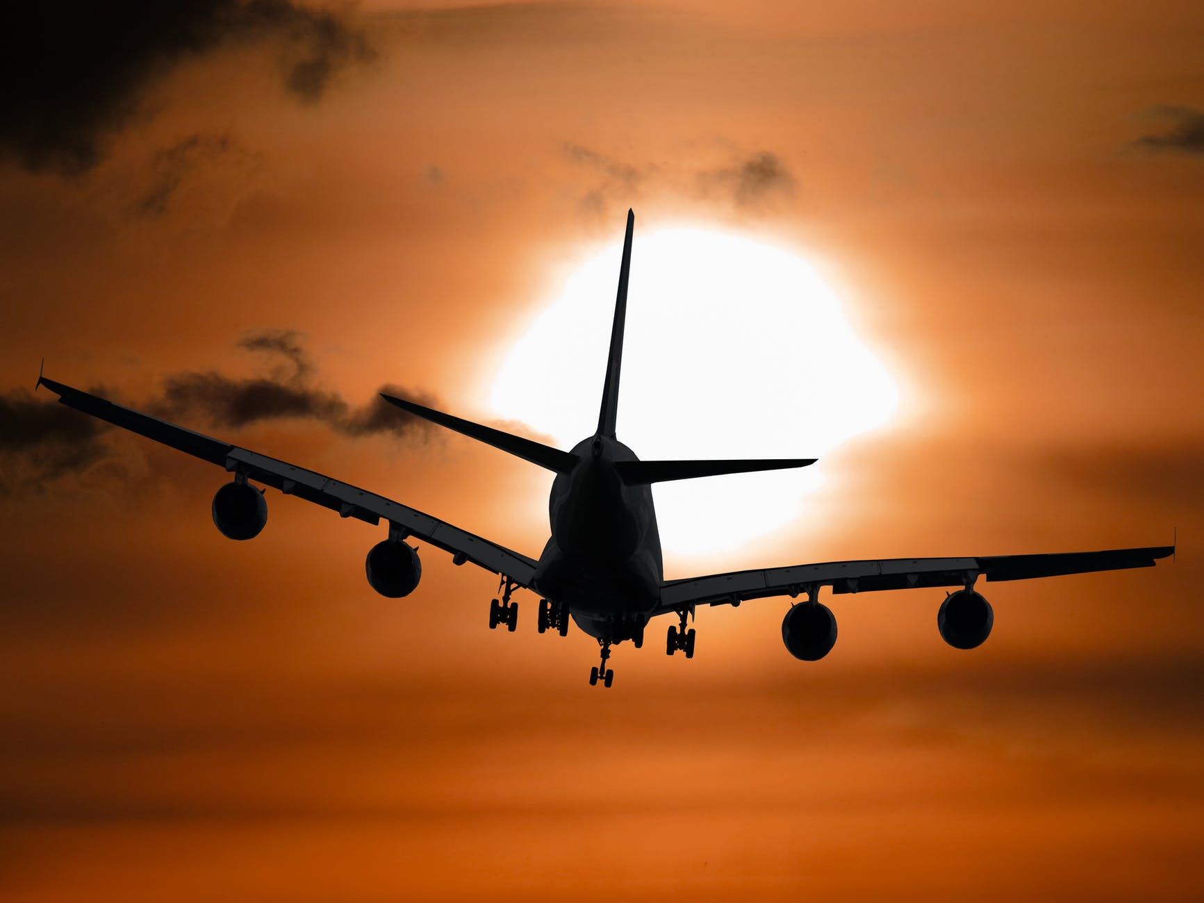 shadow image of a plane flying during sunset